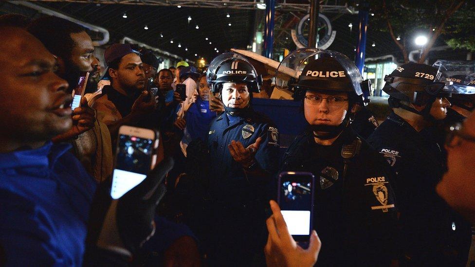 Captain Mike Campagna addresses people filming with mobile phones on the streets of Charlotte, North Carolina, on Wednesday