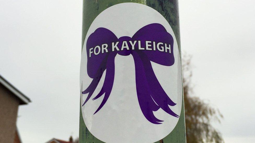 A picture of a purple sticker with For Kayleigh on it