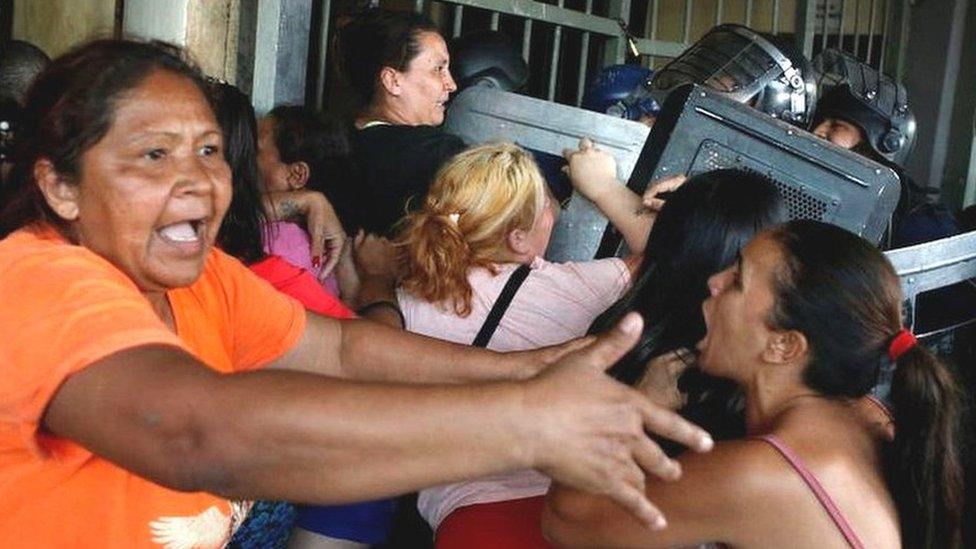 Family members clash with police outside the Tacumbu penitentiary during a riot after inmates took hostage a dozen officials and caused a fire, in Asuncion, Paraguay October 10, 2023.