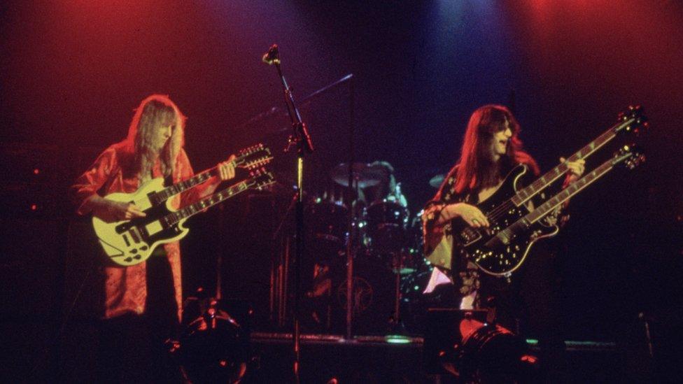 Canadian rock band Rush take the stage fronted by guitarist Alex Liefson (left) with singer and bassist Geddy Lee