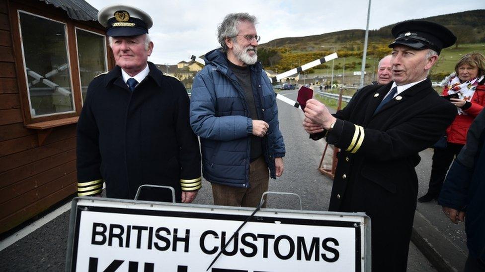 Gerry Adams jokes with a fellow protester at Killeen