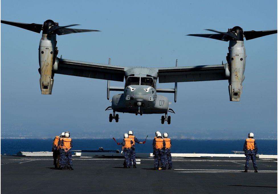 This file photo taken on 3 September 2015 shows Japanese Sailors on board the Japan Maritime Self-Defense Force (JMSDF) ship JS Hyuga directing a US Marines MV-22 Osprey to land during the Dawn Blitz 2015 exercise off the coast of Southern California.