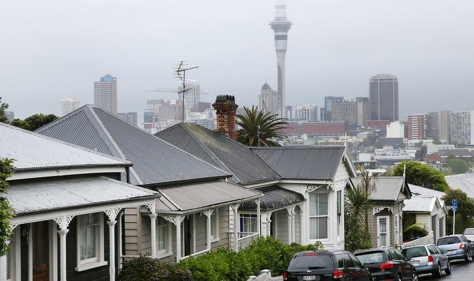 A view of a street in Auckland with the city's skyline in the background