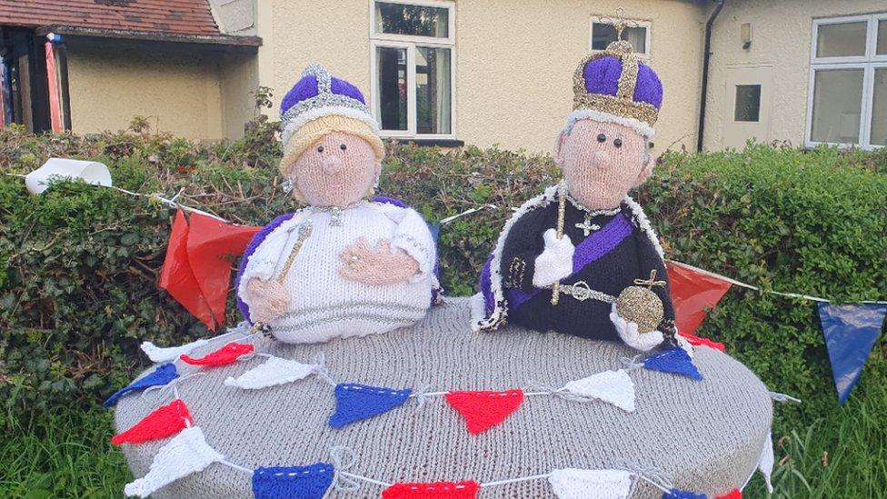 Woollen versions of King Charles and Queen Camilla surrounded by bunting