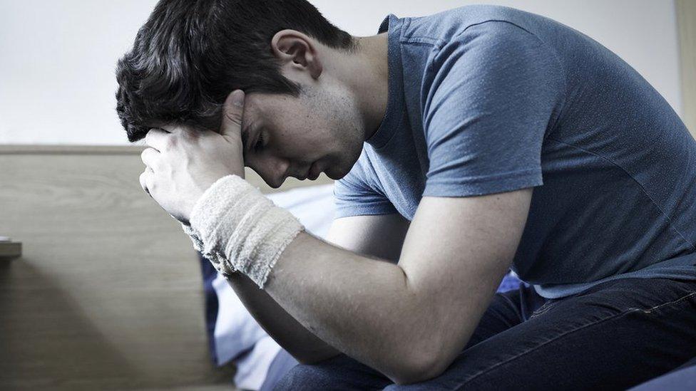 Man holding his head in his hands