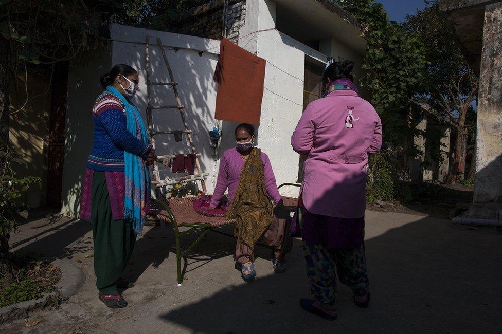 Health workers visiting homes to inform people about the vaccination