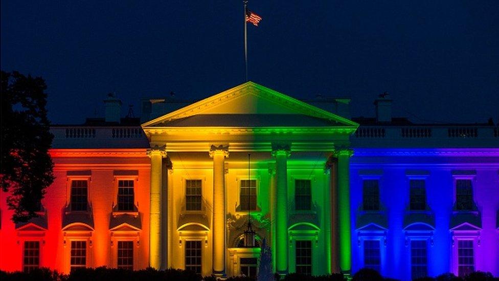 white house with rainbow colours projected onto it