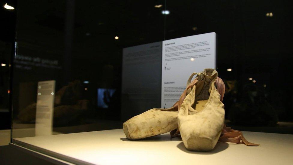 A pair of ballet shoes in a case at the exhibition