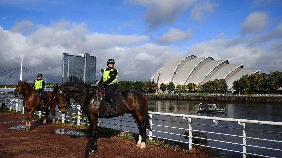 Police horses with conference venue in the background