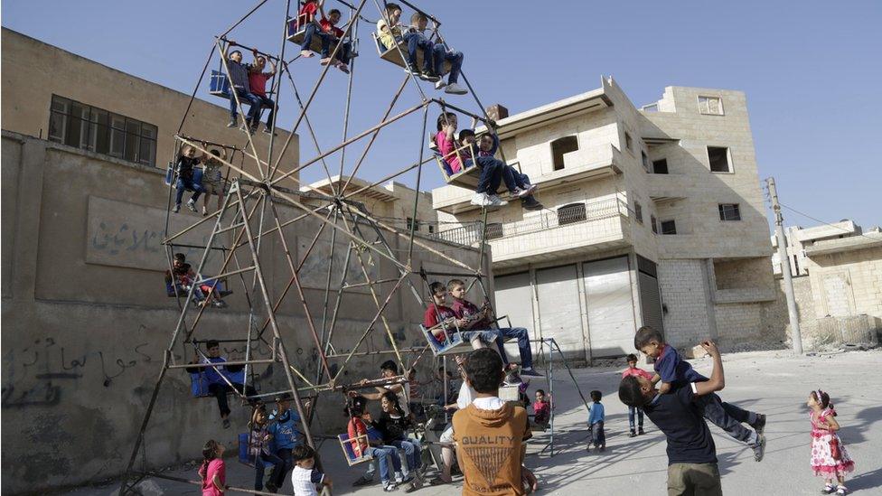 Children on a swing at Eid