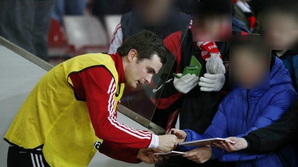 Adam Johnson signs autographs for fans