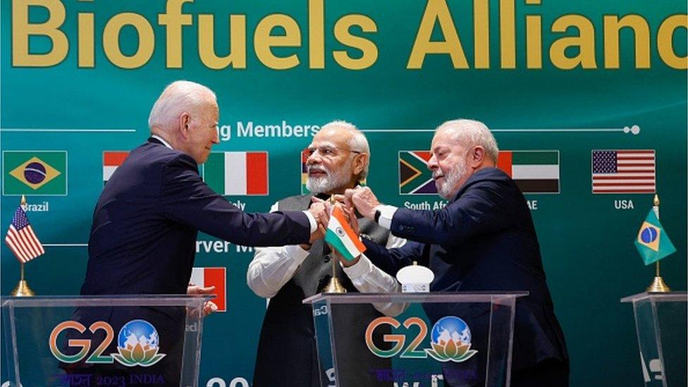 US President Joe Biden, Indian Prime Minister Narendra Modi and Brazilian President Luiz Inacio Lula da Silva hold hands