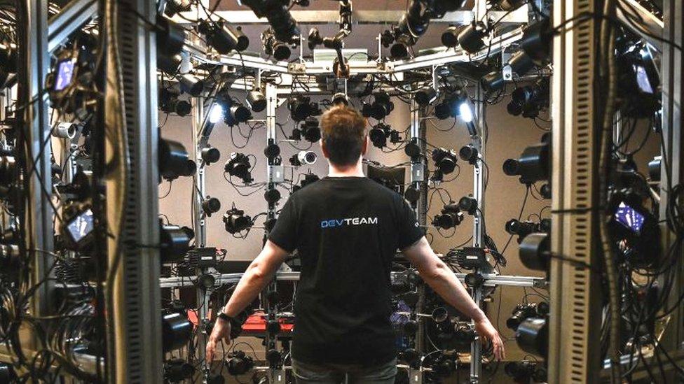 An employee stands in a cage during the presentation of a photogrammetry process at the French video games firm Quantic Dream