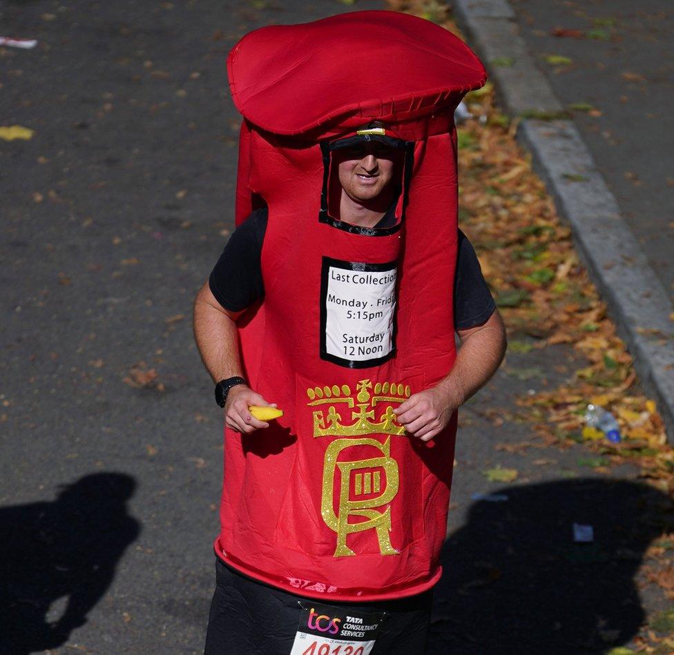 A man took on the race wearing a bright red post-box featuring the King's new cypher