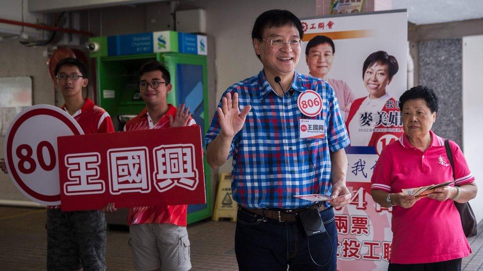 This picture taken on August 30, 2016 shows pro-Beijing candidate Wong Kwok-hing from the political party Hong Kong Federation of Trade Unions, waving while campaigning at Kwai Shing West Estate in Hong Kong ahead of the legislative council elections