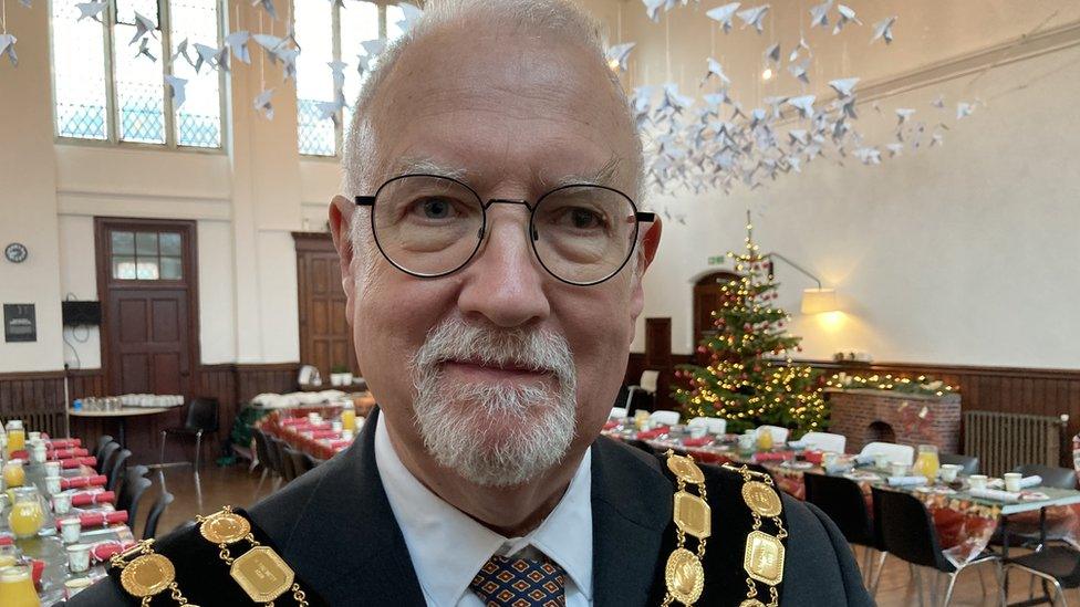 Trowbridge mayor standing inside the dining room area of the food bank