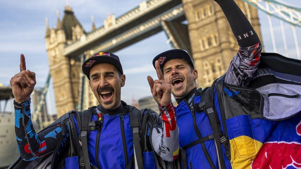 Marco Waltenspiel and Marco Fürst in their suits, cheering, with their hands in the air