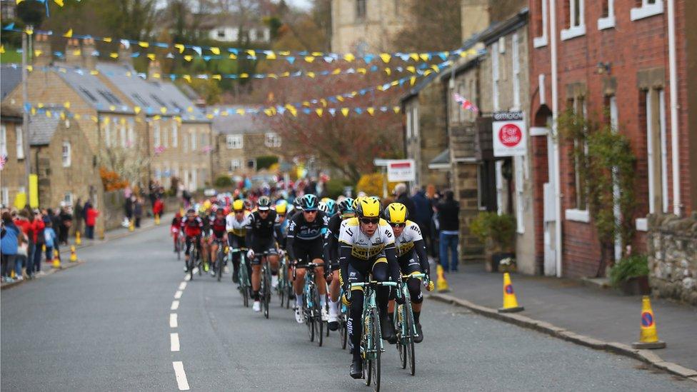 Cyclists riding through a Yorkshire town