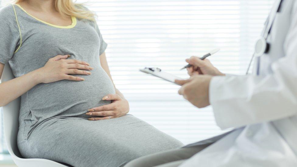 Pregnant woman with nurse