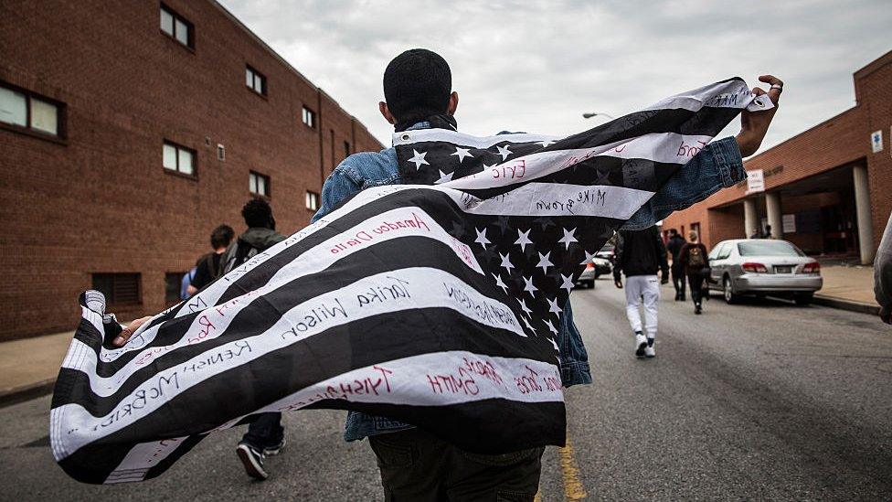 Protesters march through the streets in support of Maryland state attorney Marilyn Mosby's announcement that charges would be filed against Baltimore police officers in the death of Freddie Gray on May 1, 2015