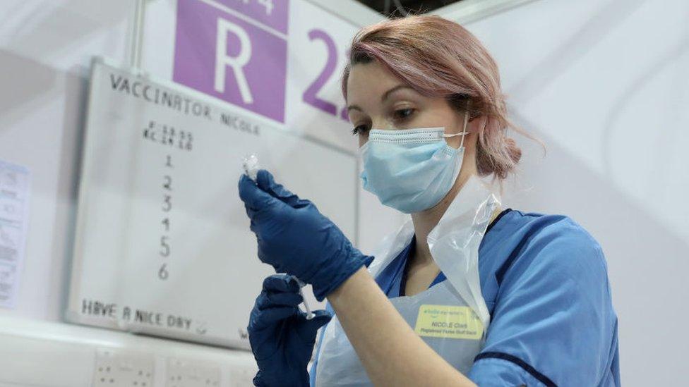 nurse giving vaccine