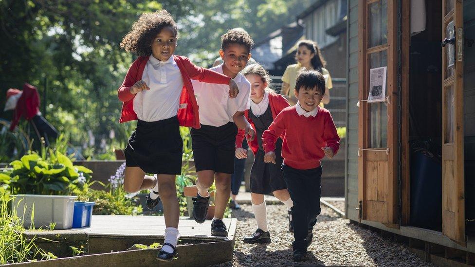 Stock image of school children running