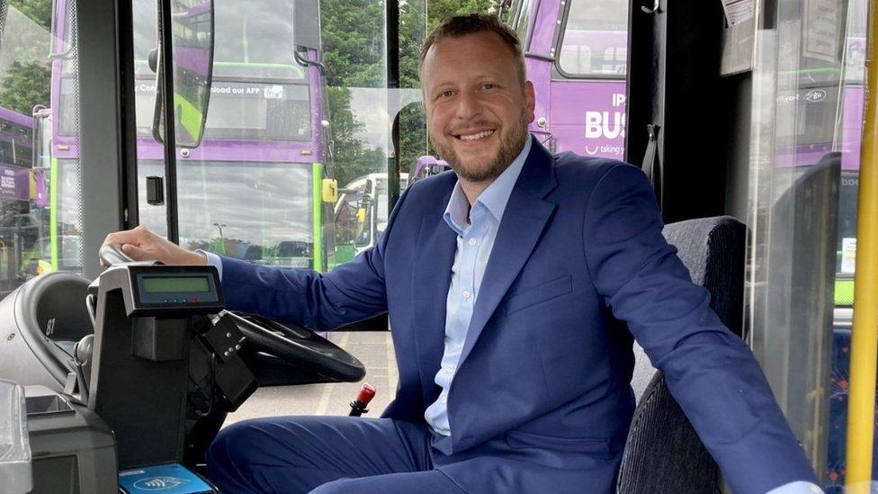 Dan Bassett sitting in bus driver's seat