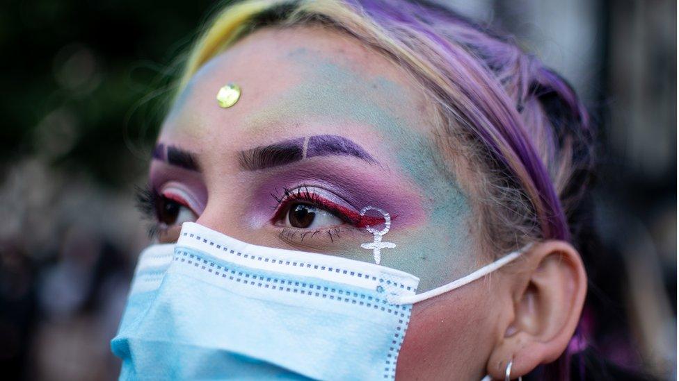 Women with painted face during International Women's Day event