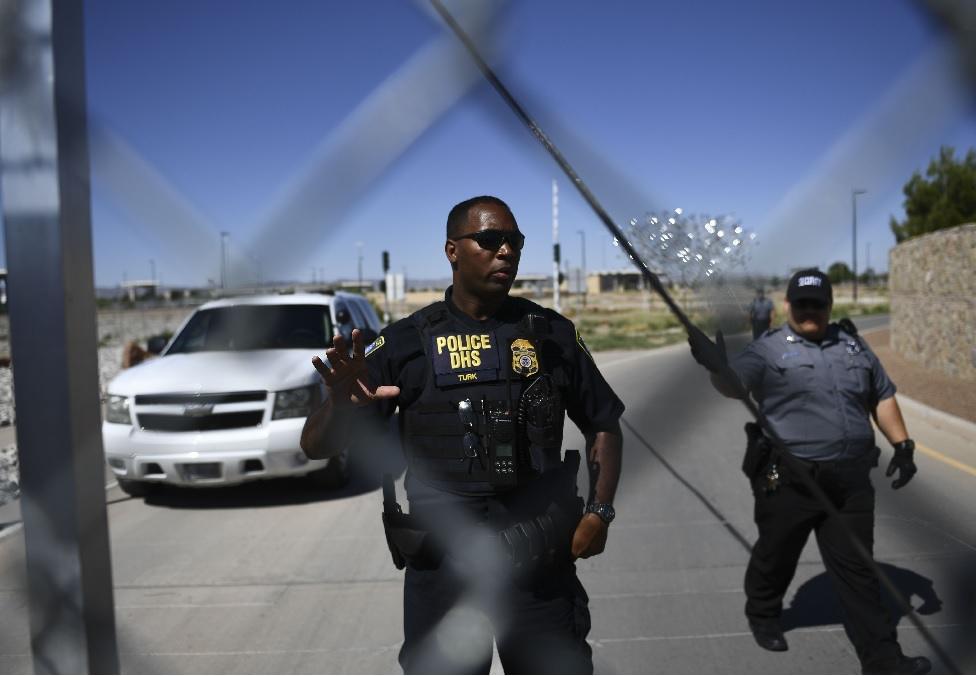 Security tell people to stop as they approach the border crossing fence at the Tornillo Port of Entry near El Paso, Texas