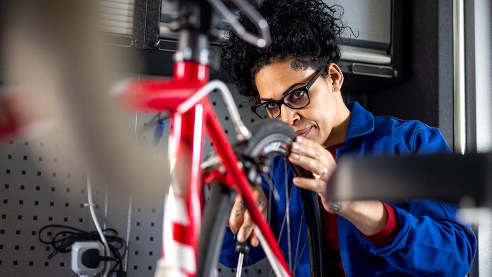 A woman works in a bike shop