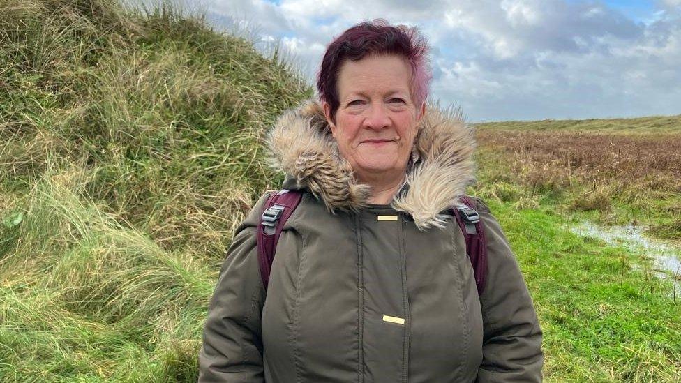 Woman stood outside amongst wildlife