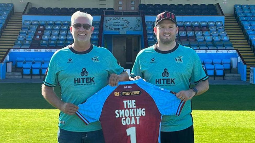 Danny Stamp holding a Scunthorpe United shirt