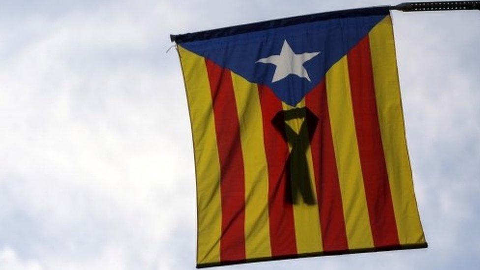 A Catalan separatist flag with a black ribbon hangs from a balcony in Barcelona, Spain, October 11, 2017.