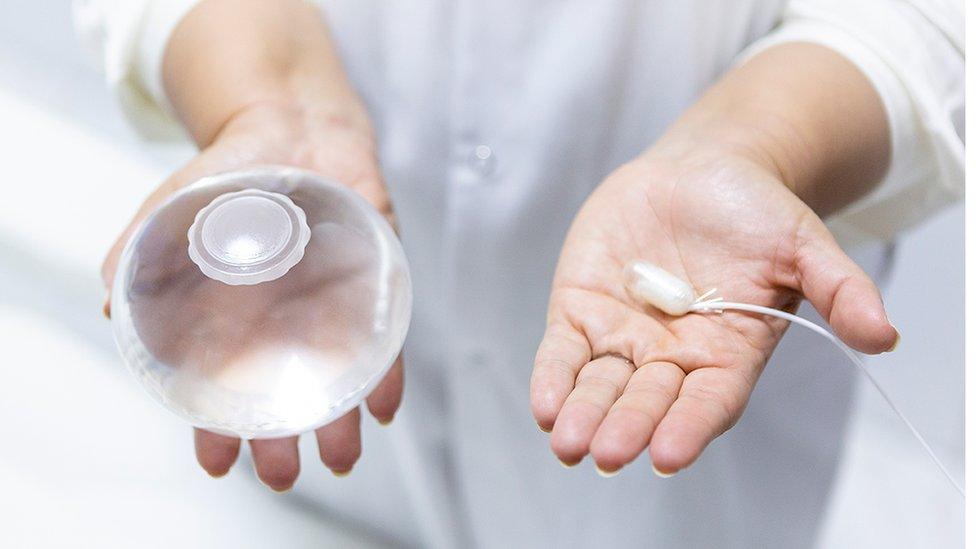 A hand held plastic bag that is filled with water