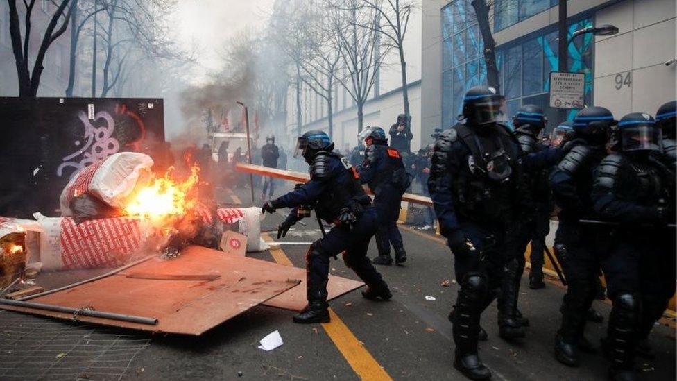 Police officers remove a barricade during a demonstration against the "Global Security Bill"", that right groups say would make it a crime to circulate an image of a police officer's face and would infringe journalists' freedom in the country, in Paris, France, on 5 December 2020.