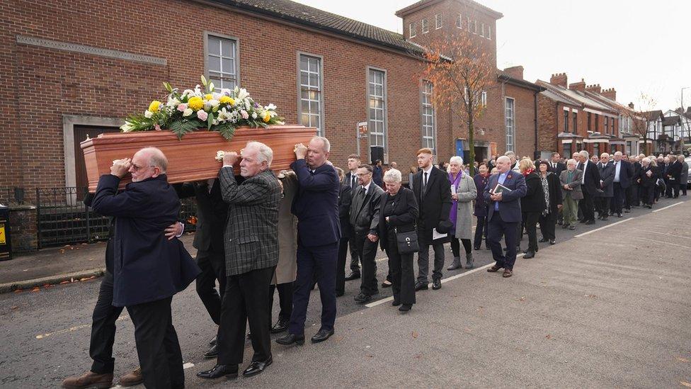 Baroness Blood's coffin being carried from Ballygomartin Presbyterian Church in Belfast after her funeral