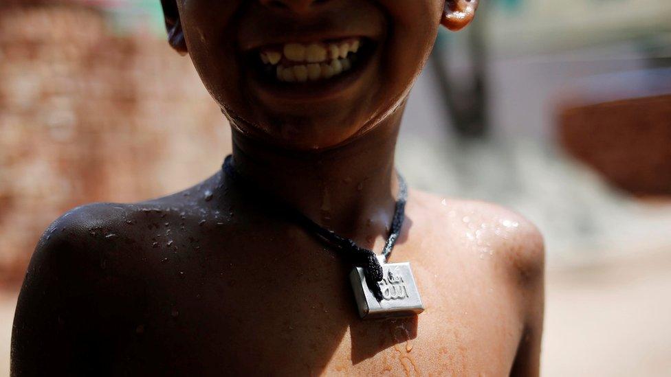 Muslim boy wears amulet