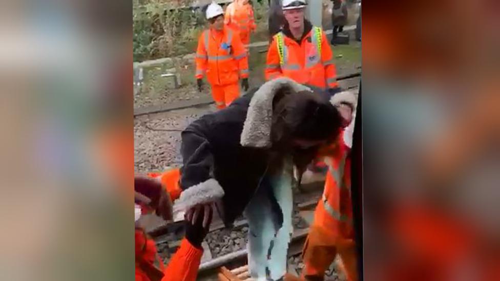 A woman is helped from the train