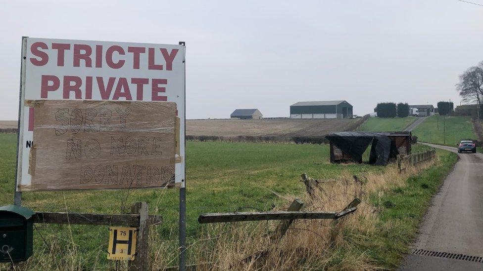 A sign by a road asking people to stop donating.