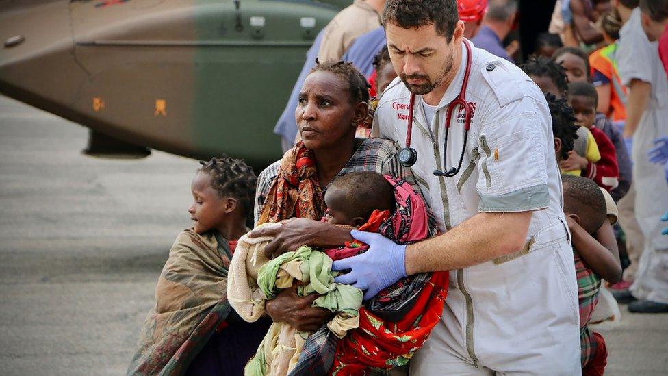 South African rescue workers with cyclone victims in Beira