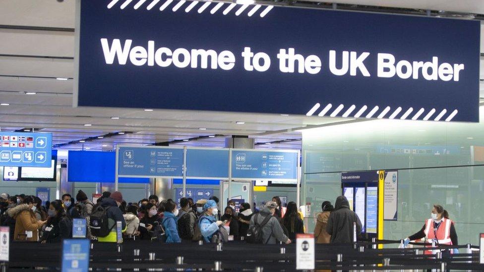 People queue at UK border control at Terminal 2 at Heathrow Airport on February 11,