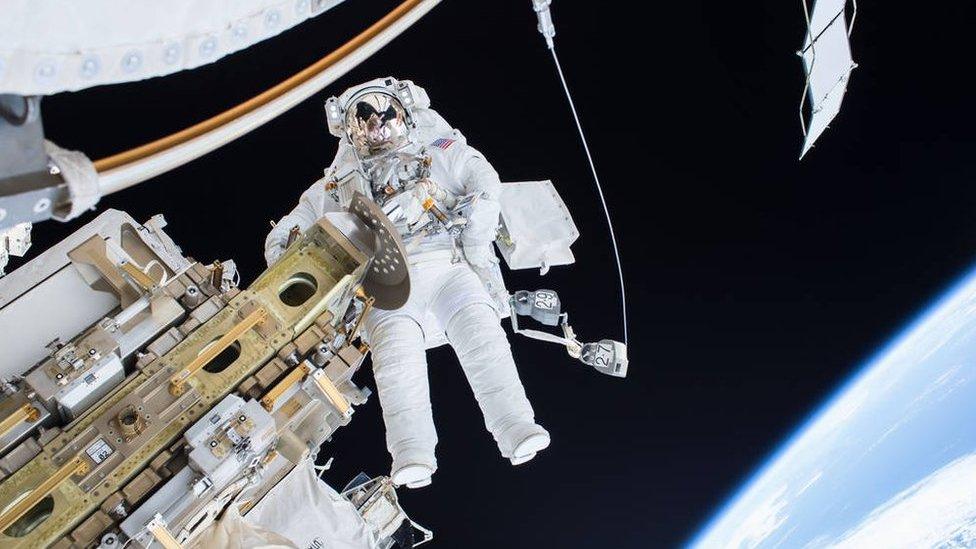 Astronaut takes a spacewalk