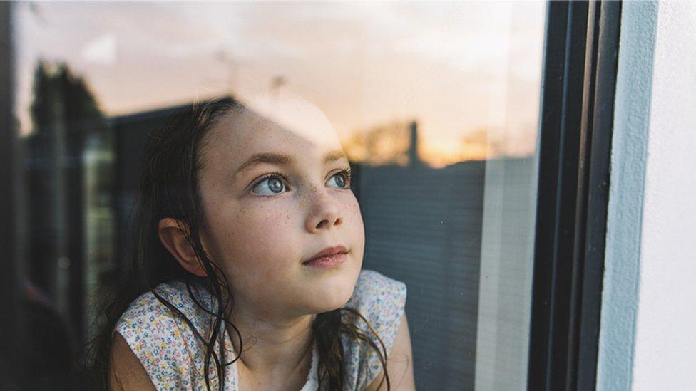 girl looking out window