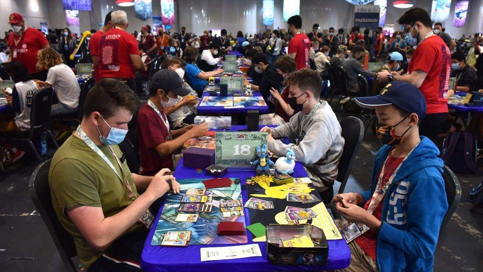 Competitors play Pokémon cards during the 2022 Pokémon World Championships