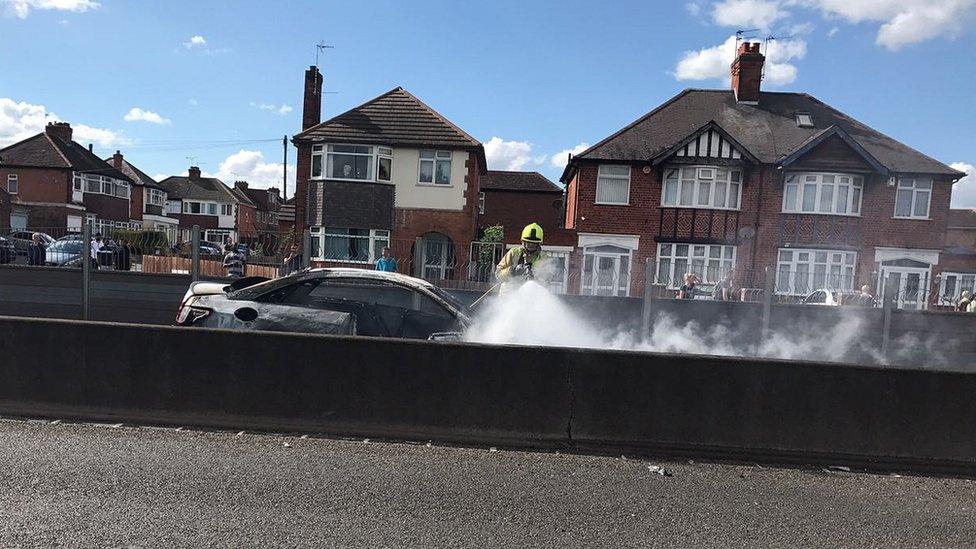 Car being put out by fire crew