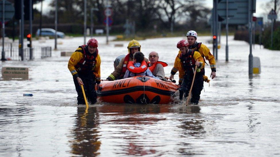 People being rescued by boat in St Asaph