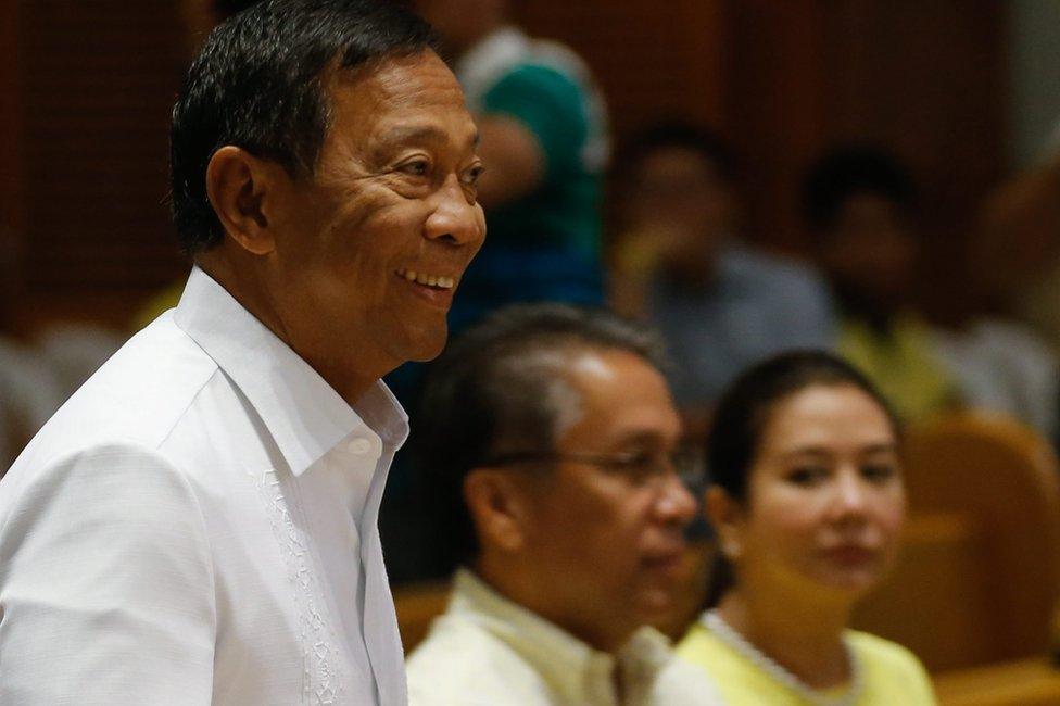 Filipino Presidential candidate Jejomar Binay (left) arrives in Manila Cathedral as Filipino Liberal Party presidential candidate, Manuel "Mar" Roxas III and his wife, broadcaster Korina Sanchez-Roxas, look on, on 2 May 2016