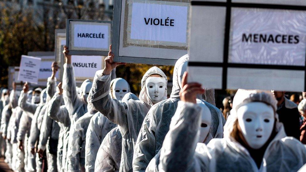 Protestors dressed in white carry placards as they take part in a demonstration in Lyon on November 24, 2018 marking the International Day for the Elimination of violence against Women