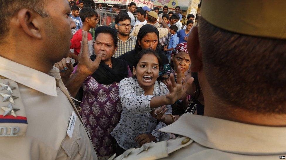 Protesters confront police outside the house of a two-and-a-half year rape victim