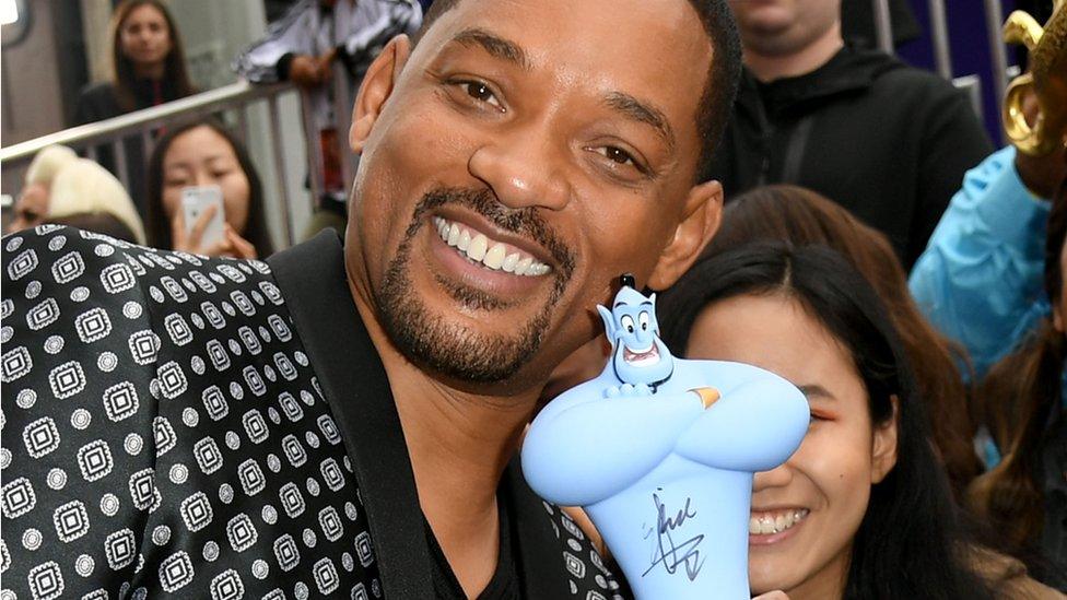 Will-Smith-poses-with-a-genie-doll.